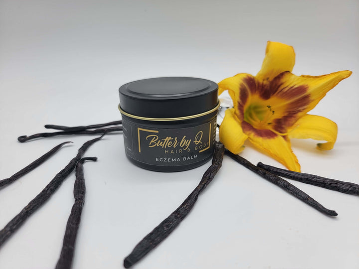 A luxe black 4 oz tin of Butter by Q's Eczema Balm made with shea butter, jojoba, rosehip & other 100% natural ingredients.