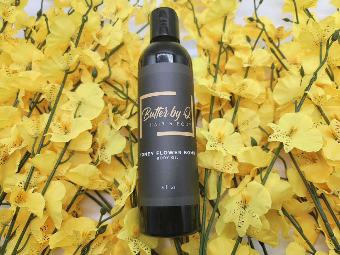 Black 8 oz body of Honey Flower Bomb Body Oil made with premium jojoba, rosehip & apricot oil & 100% natural ingredients.